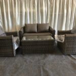 A set of rattan furniture inside a marquee